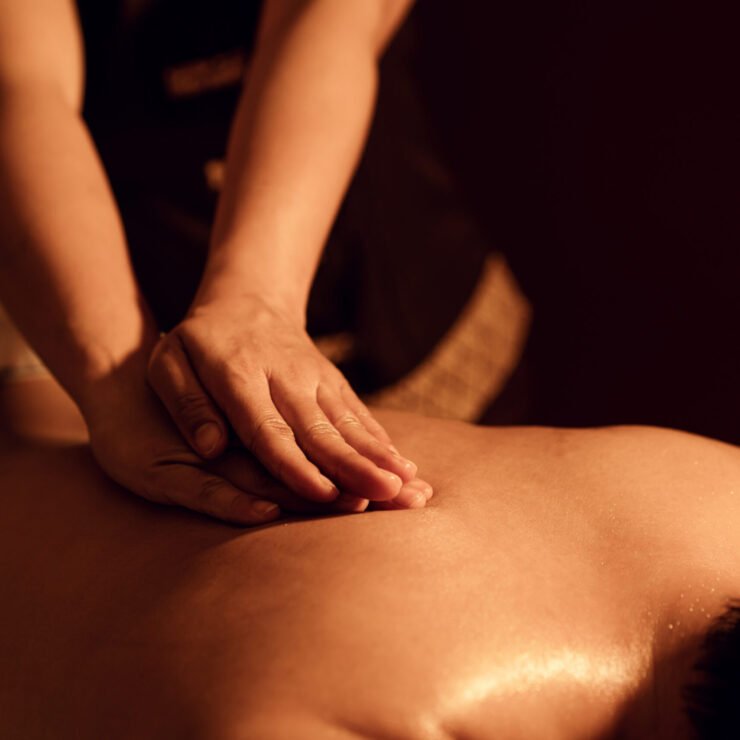 Masseuse hand massage aroma on back a man customer in cosmetology spa centre.